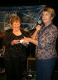 Shirley May presented with 21st birthday plaque by treasurer Bev Sharpe/PHOTO  